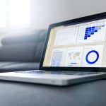 Laptop showing a conversion tracking analytics dashboard with user sessions, device and country data for South African businesses.